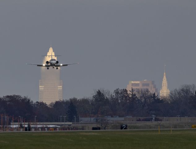 Hawker 800 (N894TX) - ERY94, a SkyQuest/Erie Shores Raytheon Hawker 900XP on short-final for RWY 24R in front of a sunlit Cleveland skyline late this afternoon, 1 Nov 2022.