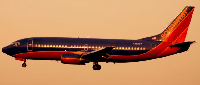 Boeing 737-700 (N388SW) - On Final 30-L (12-19-2009).  Did not realize at the time,  sunset had started, thus creating the background color and effects that are displayed.