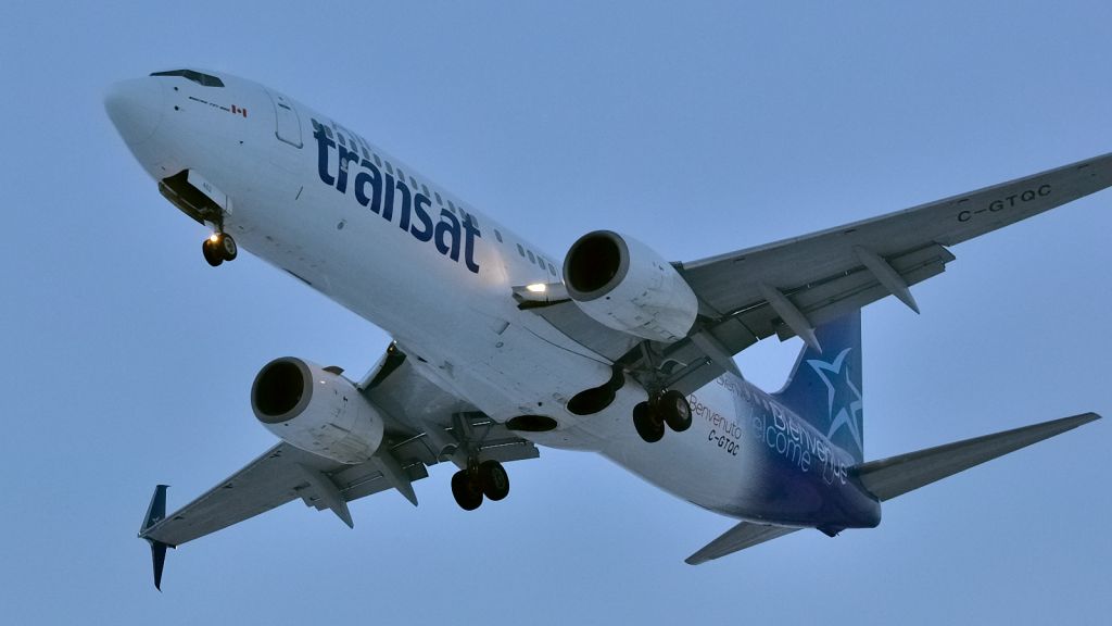 Boeing 737-800 (C-GTQC) - Short final on Rwy 24R at dusk. Completing a round trip YUL/CYUL - TNCM/SXM.