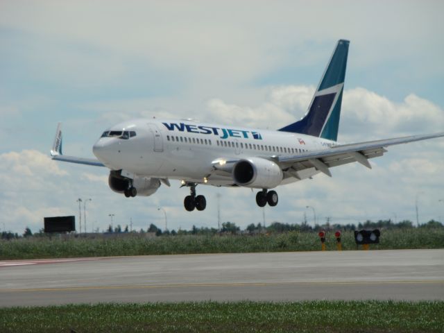 Boeing 737-700 (C-FIWS) - First aircraft to land on the new 35R/17L runway at CYYC at 14:00 (MDT) on June 28, 2014.  WS169 from CYYT.