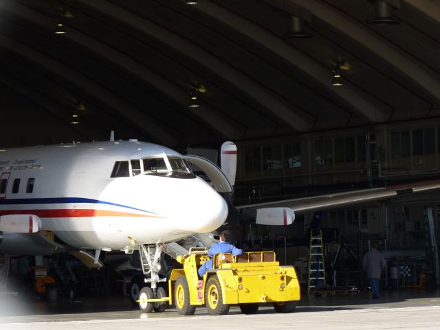 — — - NRC convair being shoved back into its hangar.