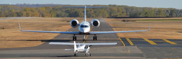 Gulfstream Aerospace Gulfstream V (N53M) - One of 3Ms corporate jets facing a small aircraft.