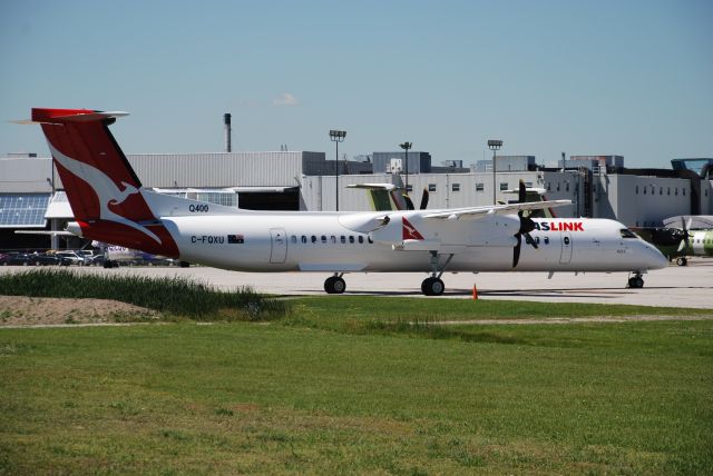 de Havilland Dash 8-200 (C-FQXU) - Bombardier Q400 c/n 4215 in QantasLink livery outside the assembly plant at Downsview Airport. July 15/08.