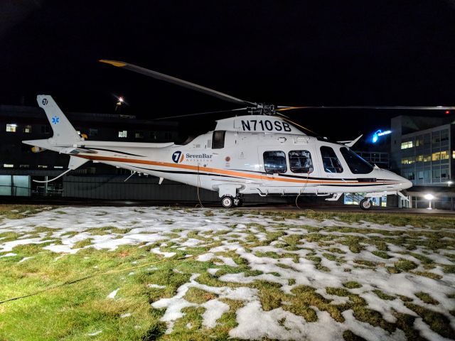 SABCA A-109 (N710SB) - N710SB (2013 AgustaWestland AW109SP, C/N 22312) rests on the helipad at Central Maine Medical Center (ME95) in Lewiston, Maine at night. Photo taken: Monday December 3, 2018 at 6:38 PM.