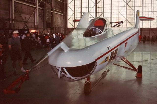 — — - The plywood sheathed M2-F1 Flying Bathtub on display at the Edwards Air Force Base open house on October 3, 1998. It was the first of NASAs lifting body research aircraft. It had just been restored to mint condition following years of being stored outside.