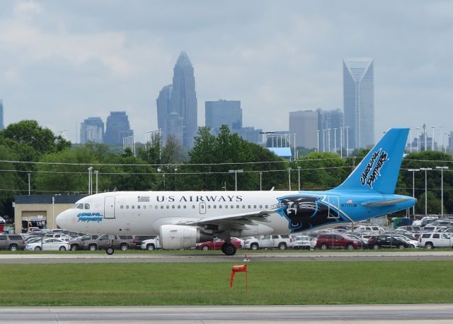 Airbus A319 (N717UW) - Carolina Panthers theme taxiing to RWY 18C. Charlotte in the background.