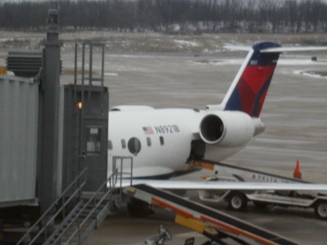 Canadair Regional Jet CRJ-200 (N8921B) - At gate D84 at KPIT off loading luggage from KDTW prior to loading for departure to KMSP on 02 06 2011