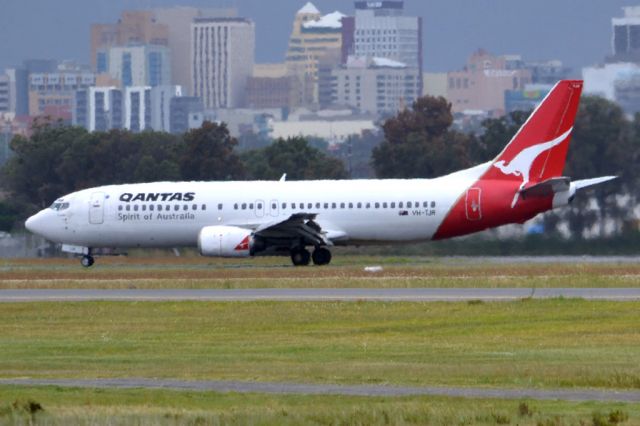 BOEING 737-400 (VH-TJR) - On taxi-way heading for Terminal 1, after landing on runway 23. Friday 5th October 2012.