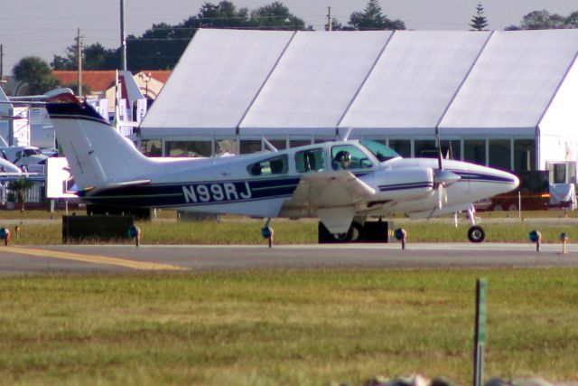 Beechcraft 55 Baron (N99RJ) - Taxiing to depart rwy 07 on 22-Oct-14  heading for MYGF.