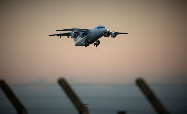 Avro Avroliner (RJ-85) (EI-RJI) - Wheels up over the fence...