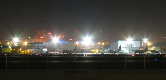 KRNO — - As seen from across the parallel runways 34L-16R and 34R-16L, all is quiet on the NevANG "High Rollers" ramp at RTIA.  A portion of the downtown Reno casino area can be seen behind the airport.