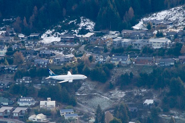 BOEING 737-300 — - 2 mile final, Runway 05, cleared to land.<br>Watching an Air New Zealand B733 carrying out a visual approach into Queenstown on Runway 05 in July 2011. I was way up high on the top of Peninsula Hill, which all aircraft have to fly around to make the approach. Its quite an unusual position to be in, having large aircraft fly down through your height, then descending below to land, flying past houses!br /Taken from about 2-3km away