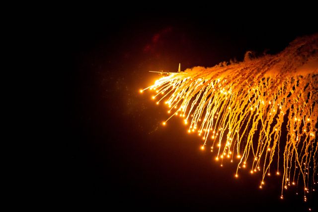 Lockheed C-130 Hercules (UNKNOWN) - Night time lights out approach & flare drop...