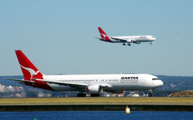 BOEING 767-300 (VH-OGO) - VH-OGO taking off from 34L with a playmate landing 34R.