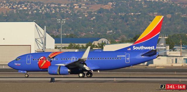 Boeing 737-700 (N409WN) - This photo, taken eight hours ago, shows Southwests "Triple Crown One" (N409WN) as the pilots employ the various systems to slow it down after completing a 6:45 AM arrival on RTIAs runway 16R at the end of a flight from KLAS.  Even though it was so early in the morning, the sun was already blazing down upon the airport grounds.  A thin layer of smoke from wildfires burning in other parts of the west had settled in to the Truckee Meadows between the Virginia Range Mountains east of Reno and the Sierra Nevada west of Reno and that thin smoke layer somewhat diffused the brilliant direct sunlight enough for me to click a properly-lit photo series of "Triple Crown One" as it landed and taxied.