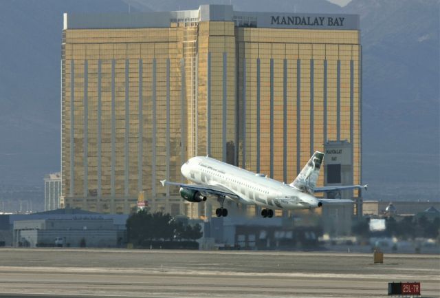 Airbus A319 (N914FR) - KLAS - March 24 2006 departure for the 'Stork" or Heron, on 25R for Denver - photo from the E. Sunset Ave airpark at Las Vegas! I have many videos and prints without the Mandalay Bay Resort/Casino in the background - I forgot how big this place is.