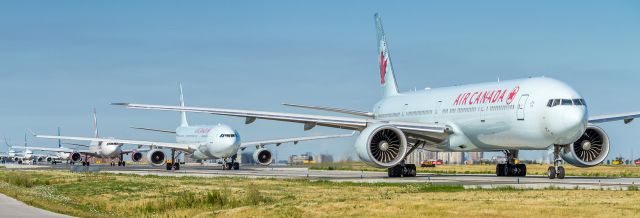 BOEING 777-300 (C-FIVQ) - Long line up for the mid-afternoon departures at YYZ. Quite the gathering today at the threshold of the 06s and not a single police officer in sight the whole afternoon! : ) Here AC872 is next to depart on her way to Frankfurt.