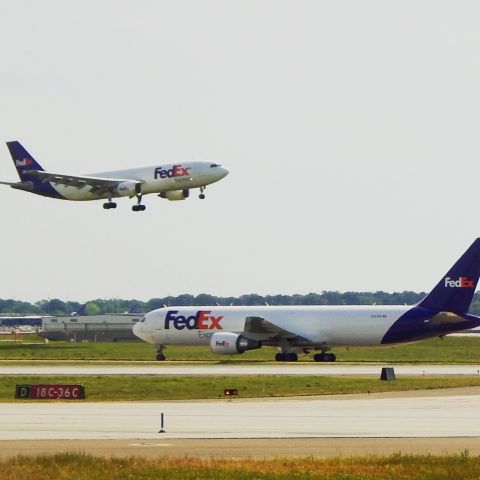 Airbus A300F4-600 (N663FE) - N663FE lands from KIAD as N101FE taxis back. Landing on 18C at KMEM, I caught this early morning flight on Sunday 3 May, 2015. 