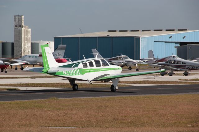 Beechcraft Bonanza (36) (N2883L) - Plane arrive and taxing back to parking spot at Peter O' Knight... Taken from helipad.