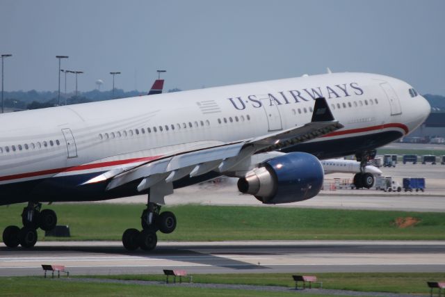 Airbus A330-300 (N276AY) - Touching down on runway 18C at KCLT - 8/16/14