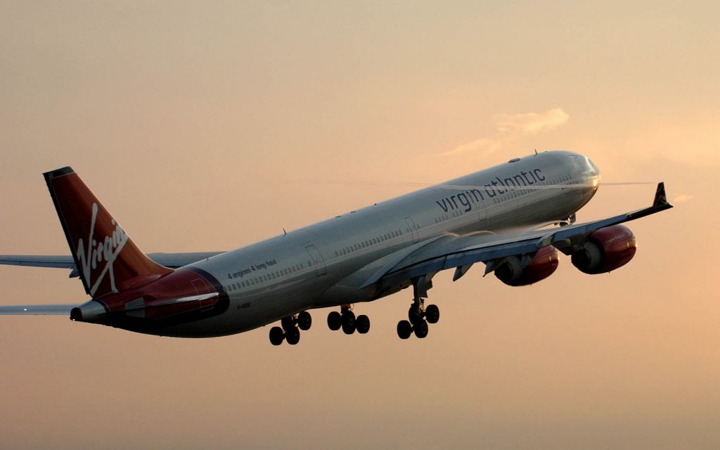 Airbus A340-600 (G-VOGE) - Taking off towards the west towards the setting sun which is reflected just under the R1 door...