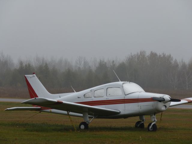 — — - tied down awaiting for its next flight. Sitting at Russ Beech air field.
