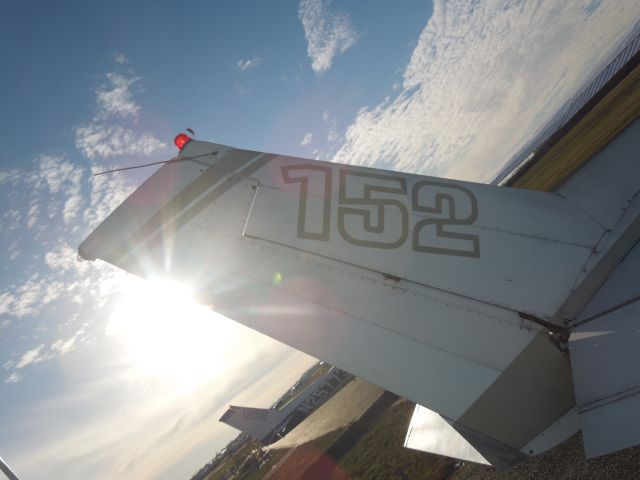 Cessna 152 (N714YH) - The tail and the sun.