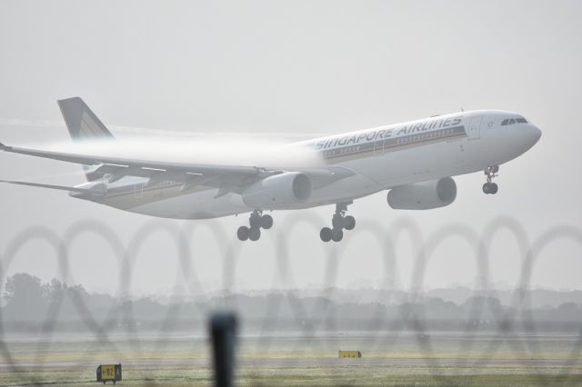 Airbus A330-300 (9V-SSH) - Singapore Airlines breaking through the fog at Brisbane Airport.