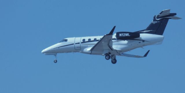 Embraer Phenom 300 (N12ML) - On short final is this 2014 Embraer Phenom 300 in the Winter of 2022.