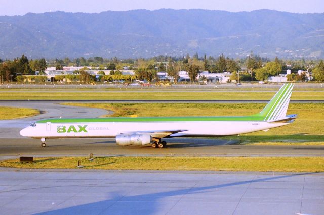 McDonnell Douglas DC-8-70 (N826BX) - KSJC - Early AM freighter arrival at San Jose - photo from the top floor of the parking structure - This jet delv new to United Airlines Oct 1968. CN 45998 LN 399. photo date mid 1990s.