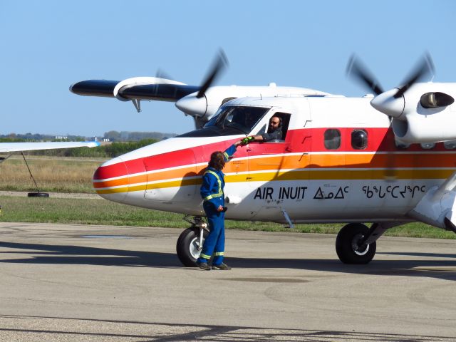 De Havilland Canada Twin Otter (C-FTJJ) - Canada DHC-6-300 Twin Otter makes a rare visit to Yorkton. Here the mechanic is seen retrieving something from the pilot prior to departure. 