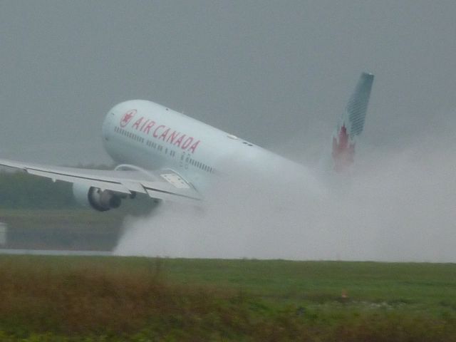 C-FMWQ — - taking off on a drenched runway #25