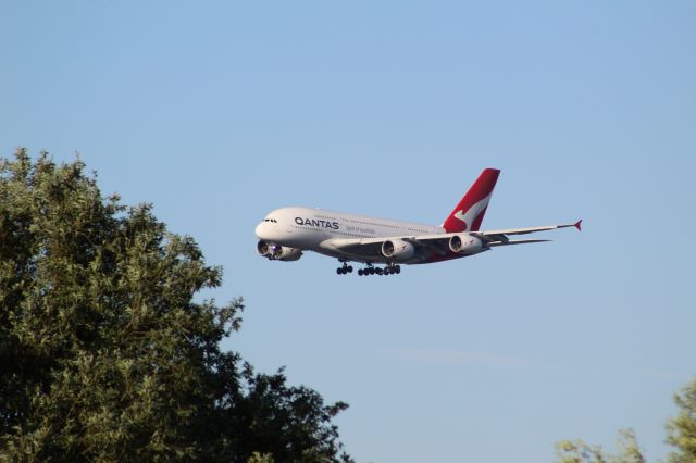 Airbus A380-800 (VH-OQJ) - A distant picture of a Qantas A380 landing into LHR on runway 09R. This image is interesting as it is the first Qantas A380 landing into LHR after it was halted a couple years ago due to COVID.br /br /Location: Stanwell Moor Road, by 09L.br /Date: 20.06.22 (dd/mm/yy).