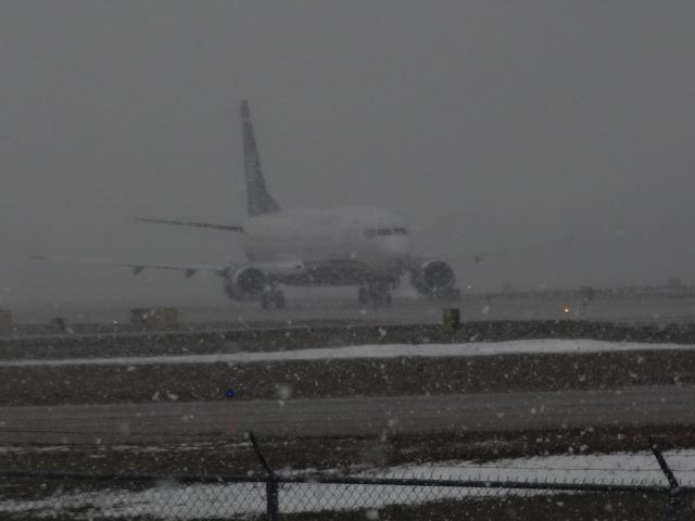 BOEING 737-400 — - AWESOME! Best day of spotting by far. Went to BUF with a friend of mine, and after catching a few others, we were caught in a blizzard but kept spotting. Glad we did, or we wouldn't have see this AWE B734! Blinded by the snow :D