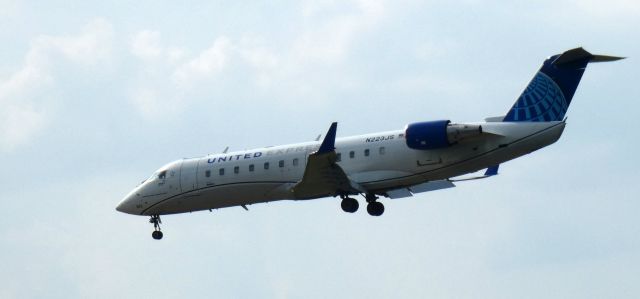 Canadair Regional Jet CRJ-200 (N223JS) - About to touch down is this 2004 United Airlines Skywest Express Canadair Regional Jet 200ER in the Summer of 2023.