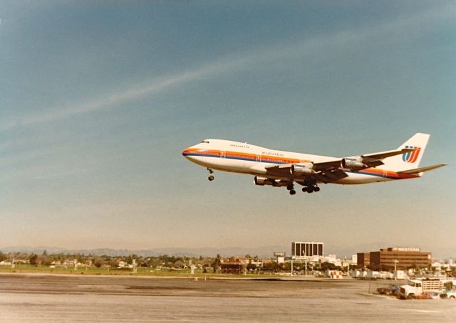 Boeing 747-200 — - United B-747 landing KLAX spring 1977. The building under the tail has a big sign stating FLY WESTERN