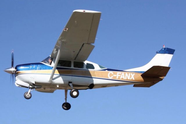 Cessna Centurion (C-FANX) - Just about to retract the gear on take off with a wave from the pilot