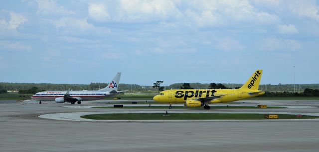 Airbus A319 (N516NK) - 6/14/23 Spirit A319 taxis past AA N921NN waiting for Rwy 17R