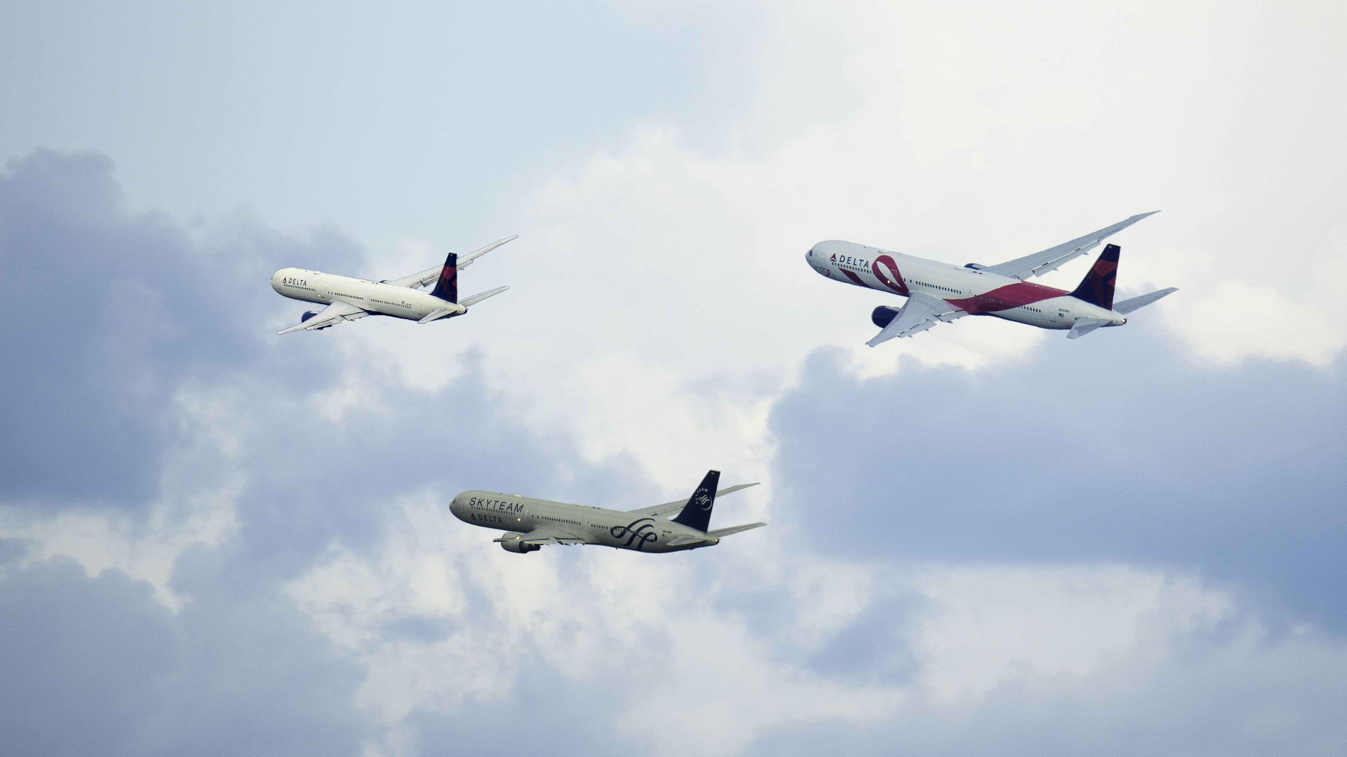 BOEING 767-400 — - I rarely get to see B764s and was hoping to catch a few when I visited KATL. I did, only they were all departing from the opposite side of the airport. Since I only got distant shots of three, I combined them into one photo.br /br /Shown departing 9L(right to left): N845MH Breast Cancer Research Foundation to Frankfurt; N844MH Sky Team to Venice; and N837MH to Munich.br /br /6/17/17