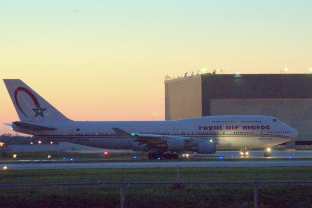 Boeing 747-400 (CN-RGA) - This Royal Air Maroc jumbo inches to Rwy 24L for the return flight to Casablanca.