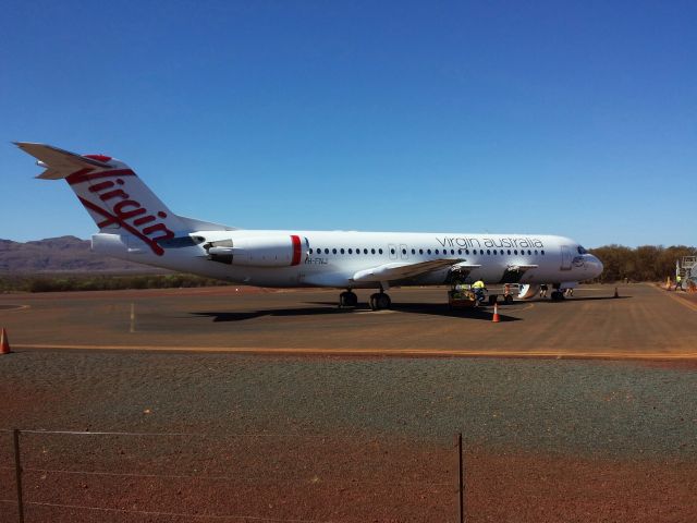 Fokker 100 (VH-FNJ) - Rebadged Skywest Fokker 100 in Virgin Australias colours on the apron at West Angelas airport catering for FIFO workers in Western Australias Pilbara.