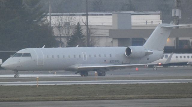 Canadair Regional Jet CRJ-200 (N258PS) - White CRJ taxiing out of Signature Flight Support KBUF for a Rnwy 14 departure!!