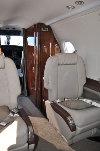 Pilatus PC-12 (N315NG) - Aft facing seats with enclosed lavatory located in wood-paneled compartment