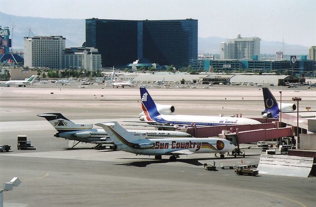 BOEING 727-200 (N283SC) - KLAS - International dock at KLAS on July 25th 1995. Nice to see the Air Transat L-1011 and the Royal Airlines L-1011. The Bellagio Resort has not been built yet.