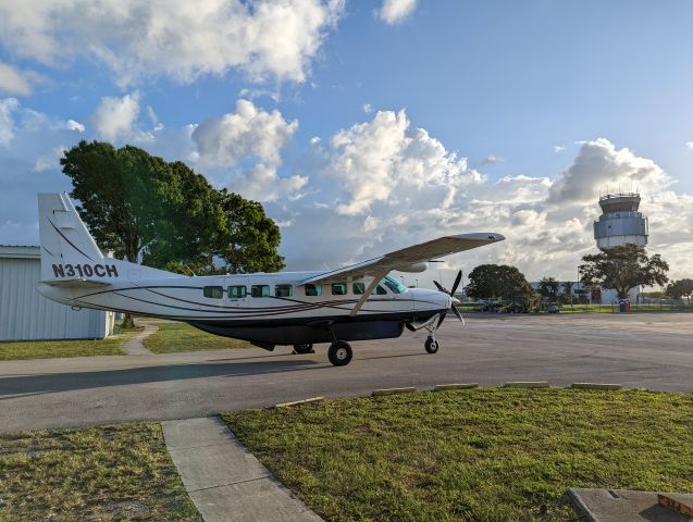 Cessna Caravan (N310CH) - A Cessna Caravan parked outside, with Fort Lauderdale Executive Tower in the background