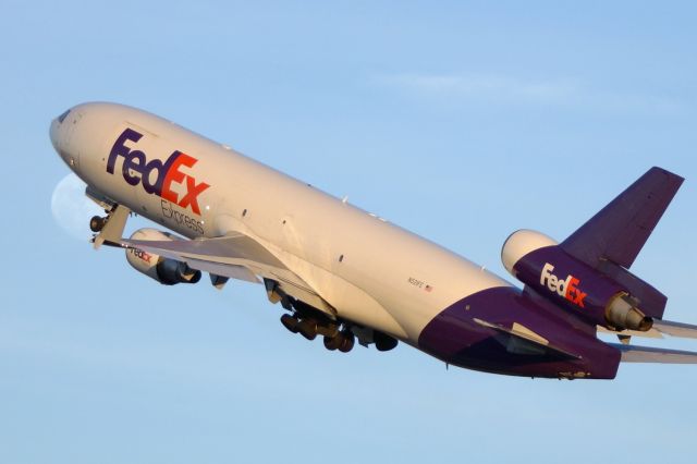 Boeing MD-11 (N521FE) - 4 departure 2-9-17 passing in front of rising moon just before sunset.