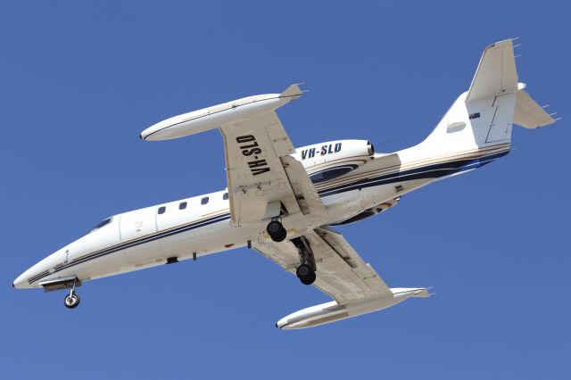 Learjet 35 (VH-SLD) - On approach to Townsville Airport. Note the hard points, or struts under each wing, used to mount sensors for observation, during Military Exercises.