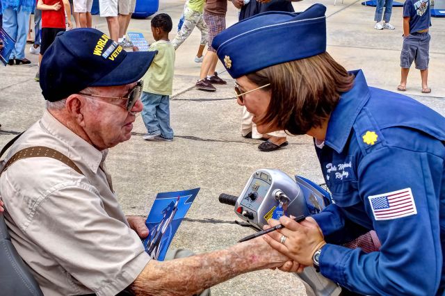 — — - Maj. Nicole Malachowski, right wing pilot for the the U.S. Thunderbirds, greets and talks with a WWII veteran at a Moody AFB Open House airshow.