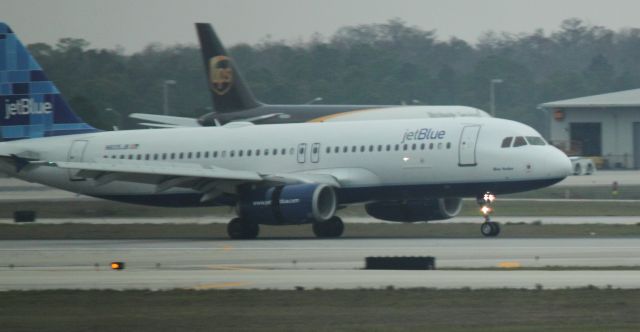 Airbus A320 (N605JB) - Just prior to nosewheel touching down at RSW on 02/11/2011