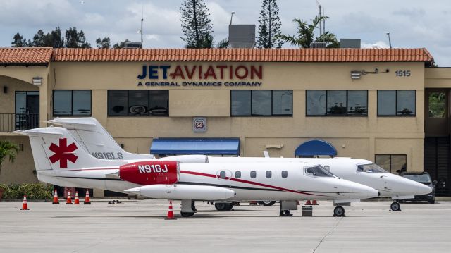 Learjet 35 (N91GJ) - LJ35 (1975) on the Jet Aviation ramp at Palm Beach formatting with e newer LJ75 N918LS ...